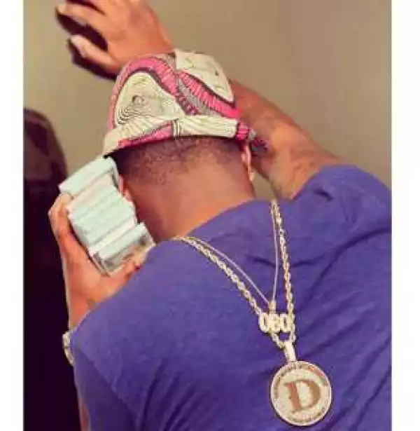 Davido Flaunts His New POLICE Number Plate And Stack Of Dollar Bills (Photos)